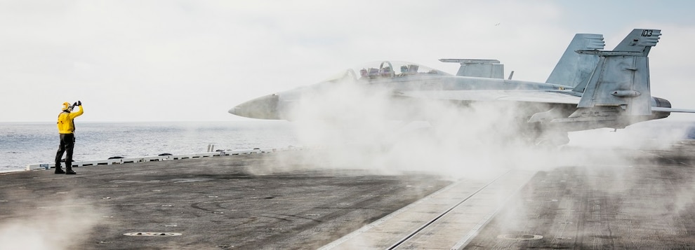 Aviation Boatswain’s Mate (Aircraft Handling) 3rd Class Airman Kareem Crump, from Chicago, assigned to air department’s flight deck crash and salvage division, directs an F/A-18F Super Hornet, attached to the Diamondbacks of Strike Fighter Squadron (VFA) 102, on the flight deck of Nimitz-class aircraft carrier USS George Washington (CVN 73) while underway in the Pacific Ocean, Oct. 2, 2024.