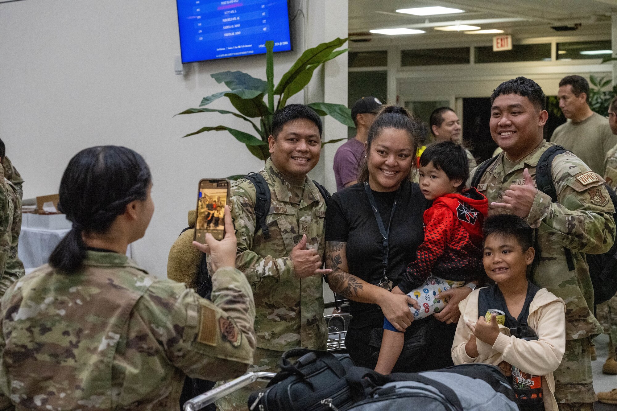 U.S. Air Force Airmen take a group photo with loved ones.