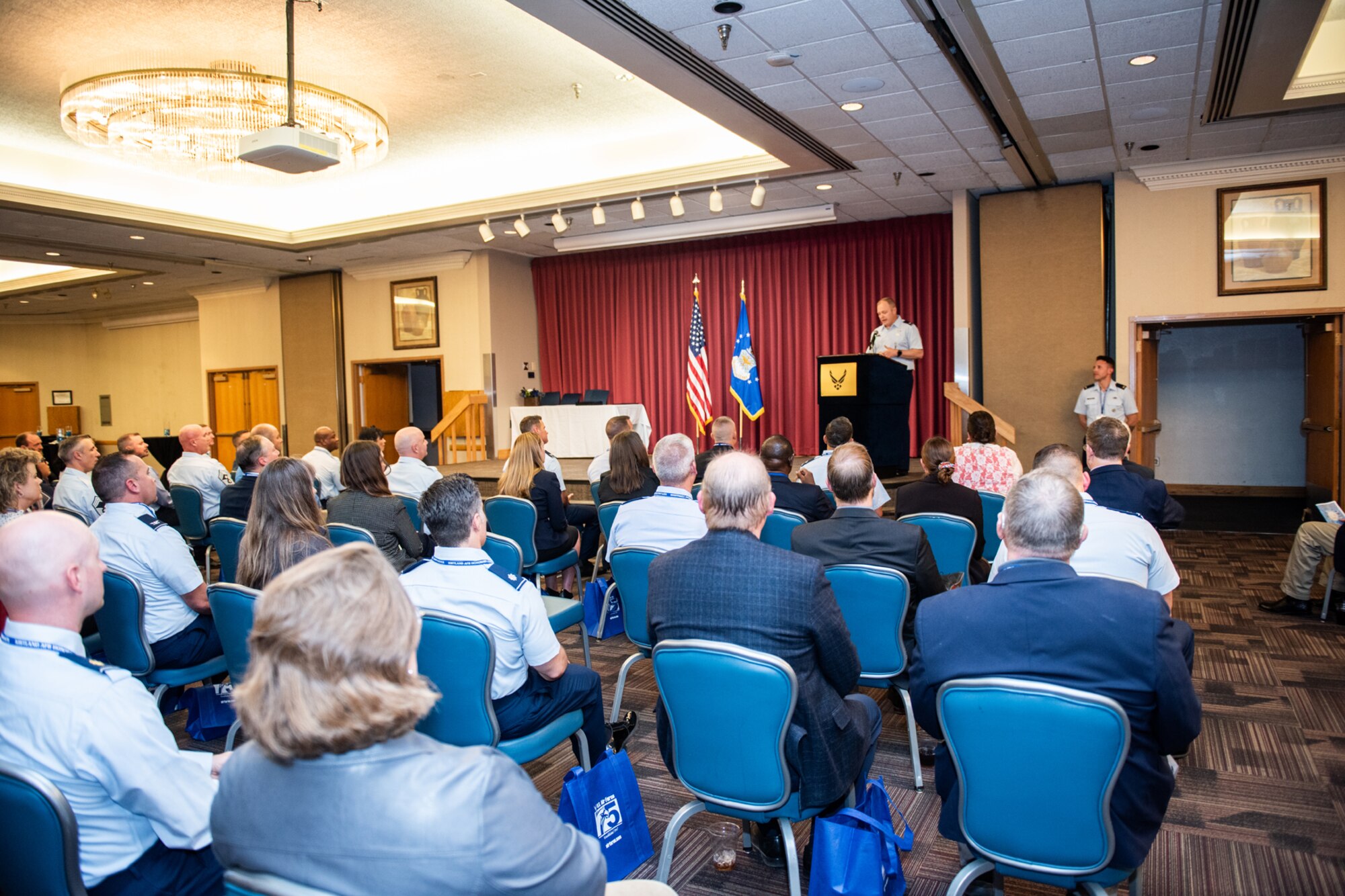 a group of people listening to a presenter speak