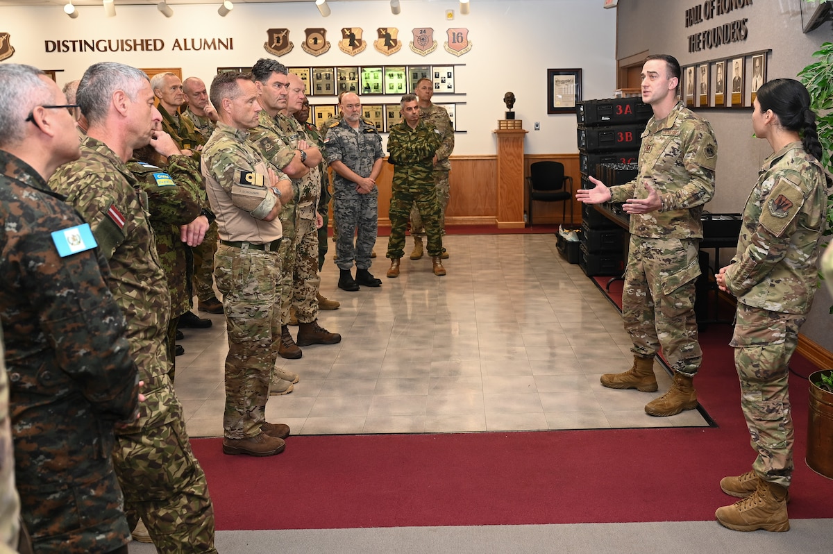 Airman shows intel equipment to Attachés.
