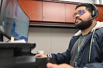 man typing on computer