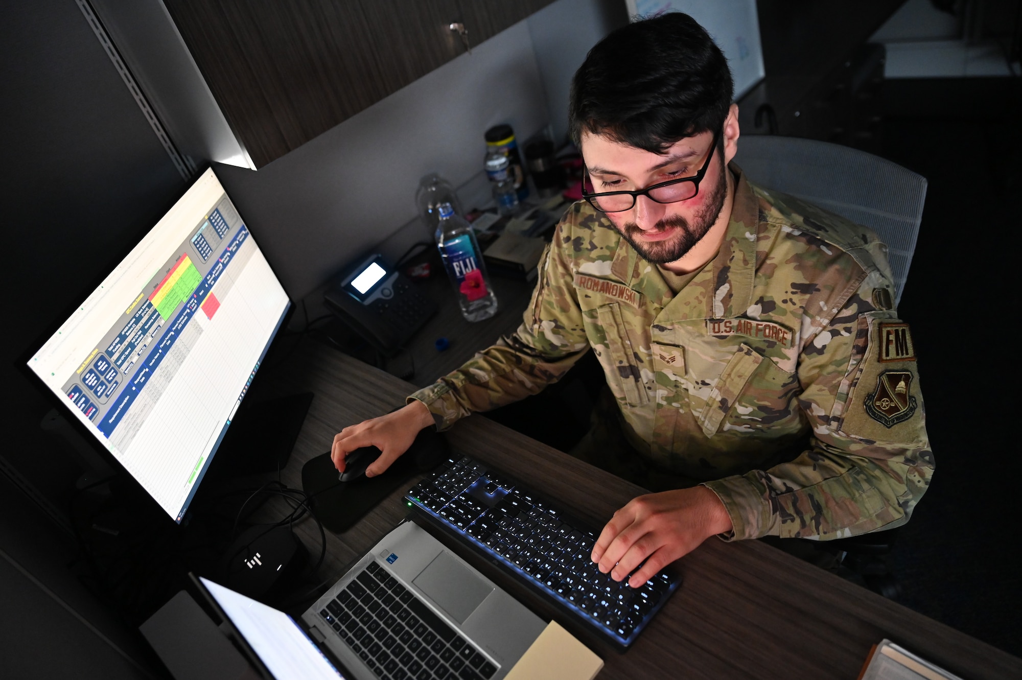 man typing on computer