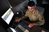 man typing on computer