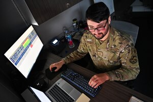 man typing on computer