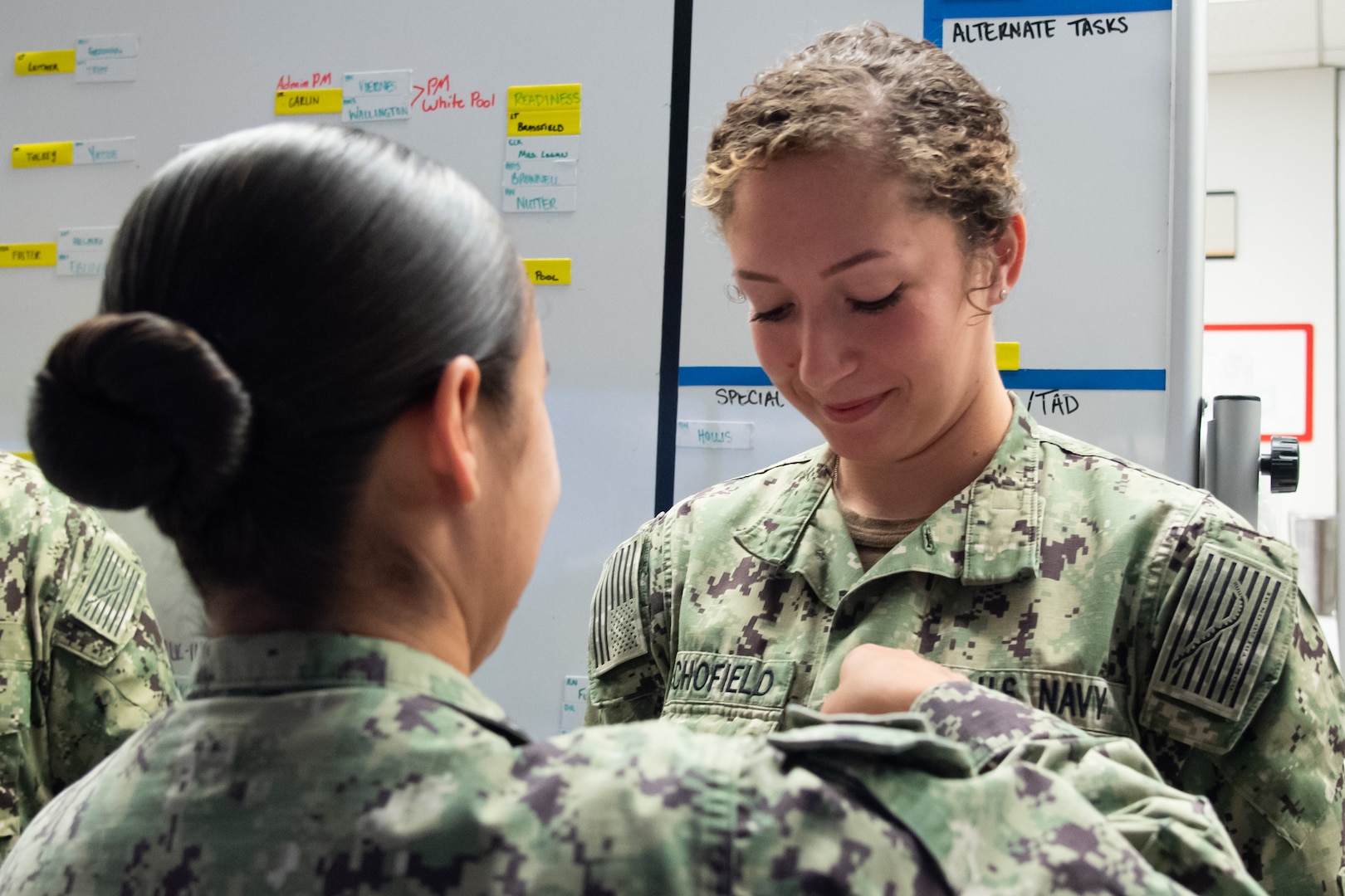 Petty Officer Second Class Vanessa Schofield meritoriously advanced to the rank during a surprise ceremony Tuesday, October 1 aboard Naval Health Clinic Cherry Point.  Page serves in the clinic’s Patient Centered Medical Home Port.  Petty Officer First Class Emily Page, left, pins Schofield’s new rank upon her.