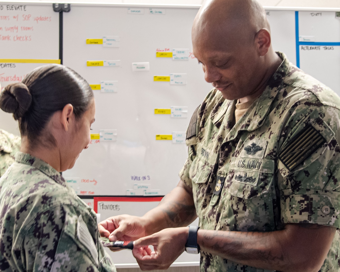 Petty Officer First Class Emily Page meritoriously advanced to the rank during a surprise ceremony Tuesday, October 1 aboard Naval Health Clinic Cherry Point.  Page serves in the clinic’s Patient Centered Medical Home Port.  Chief Petty Officer Luis Brown, right, pins Page’s new rank upon her.