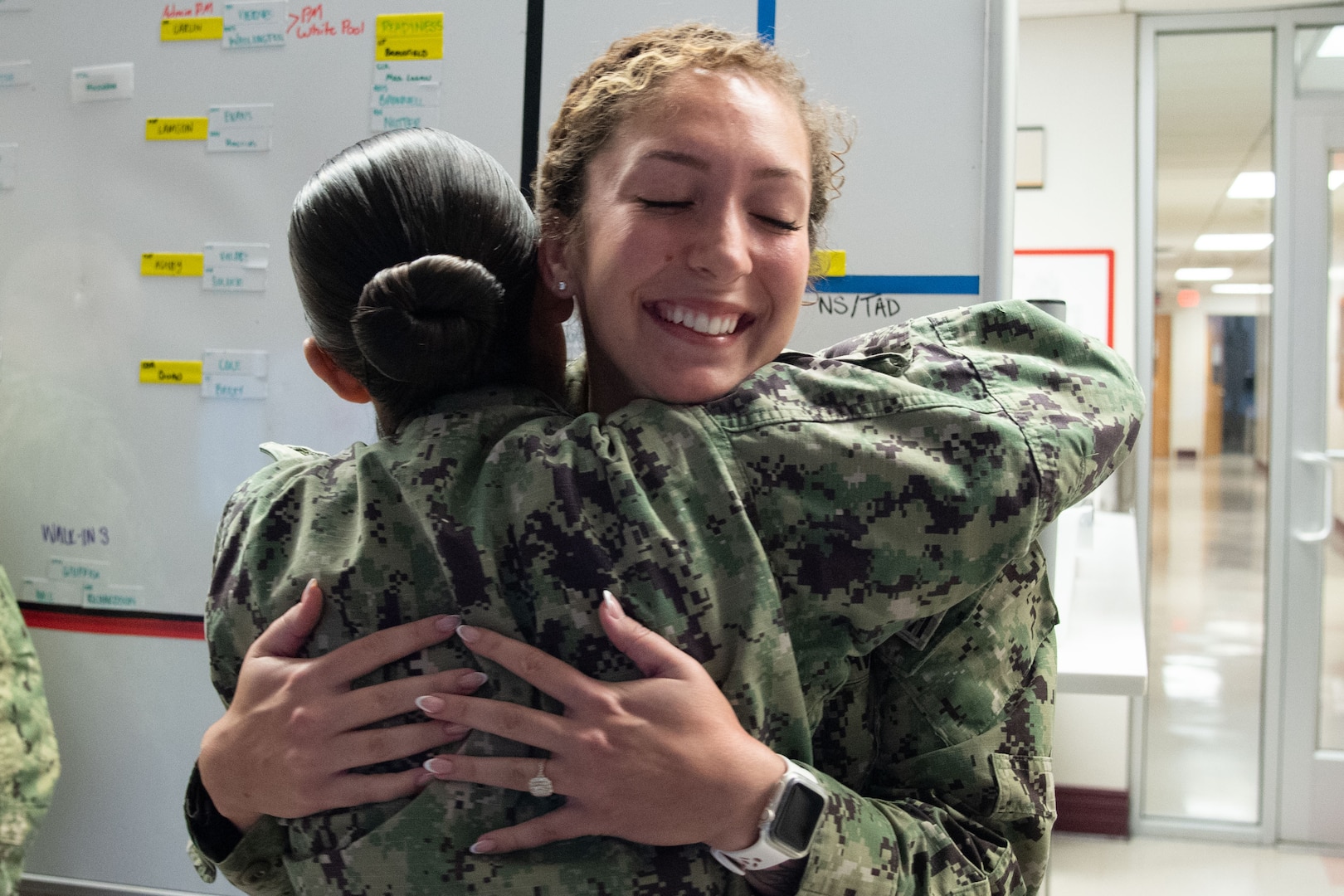 Petty Officer First Class Emily Page, left, embraces Petty Officer Second Class Vanessa Schofield after pinning her new rank upon her during a ceremony celebrating her meritorious advancement Tuesday, October 1, 2024 aboard Naval Health Clinic Cherry Point.  Both Scofield and Page received meritorious promotions during the surprise ceremony.