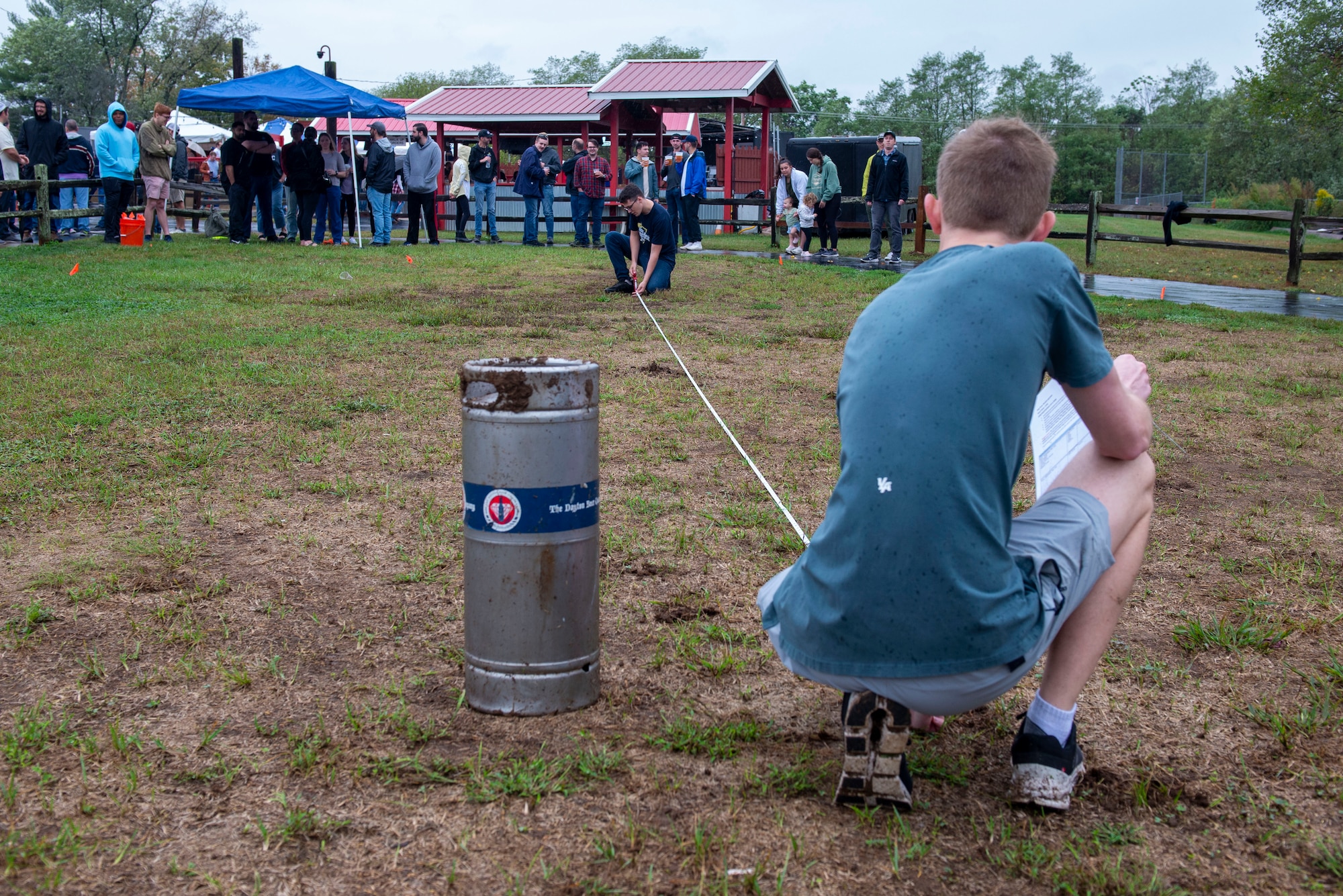 National Air and Space Intelligence Center personnel gather around during the keg tossing competition at the orginization's 56th annual Oktoberfest celebration at the Rip Rap Roadhouse, Dayton, Ohio, September 27, 2023. The history of keg tossing can be traced back to the Highland games, where variations of the event have been performed for centuries.