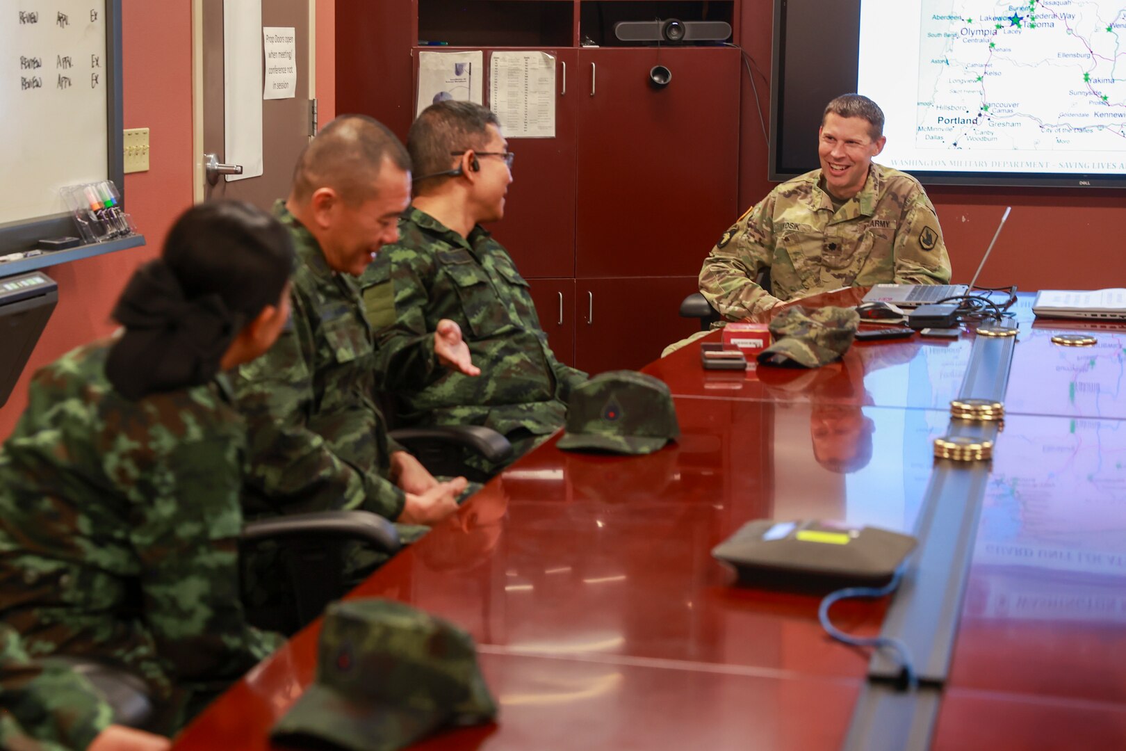 U.S. Army Lt. Col. Keith Kosik, Washington National Guard State Partnership Program director and Lt. Col. Joel Johnson, Washington bilateral affairs officer, Thailand, deliver an introduction to the Washington Military Department to members of the Royal Thai Army during a humanitarian aid and disaster relief subject matter expert exchange on Camp Murray, Wash., Sept. 24, 2024.