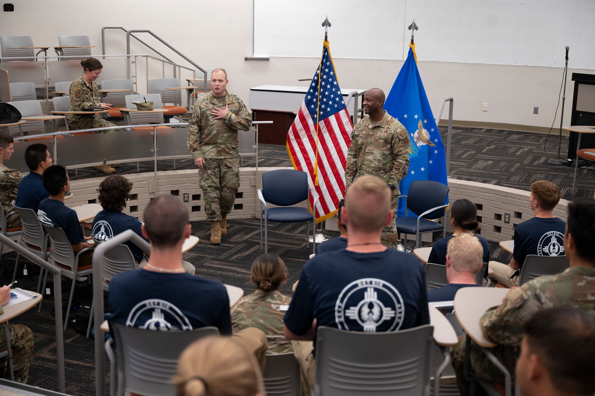 A group of people listen to a presentation.