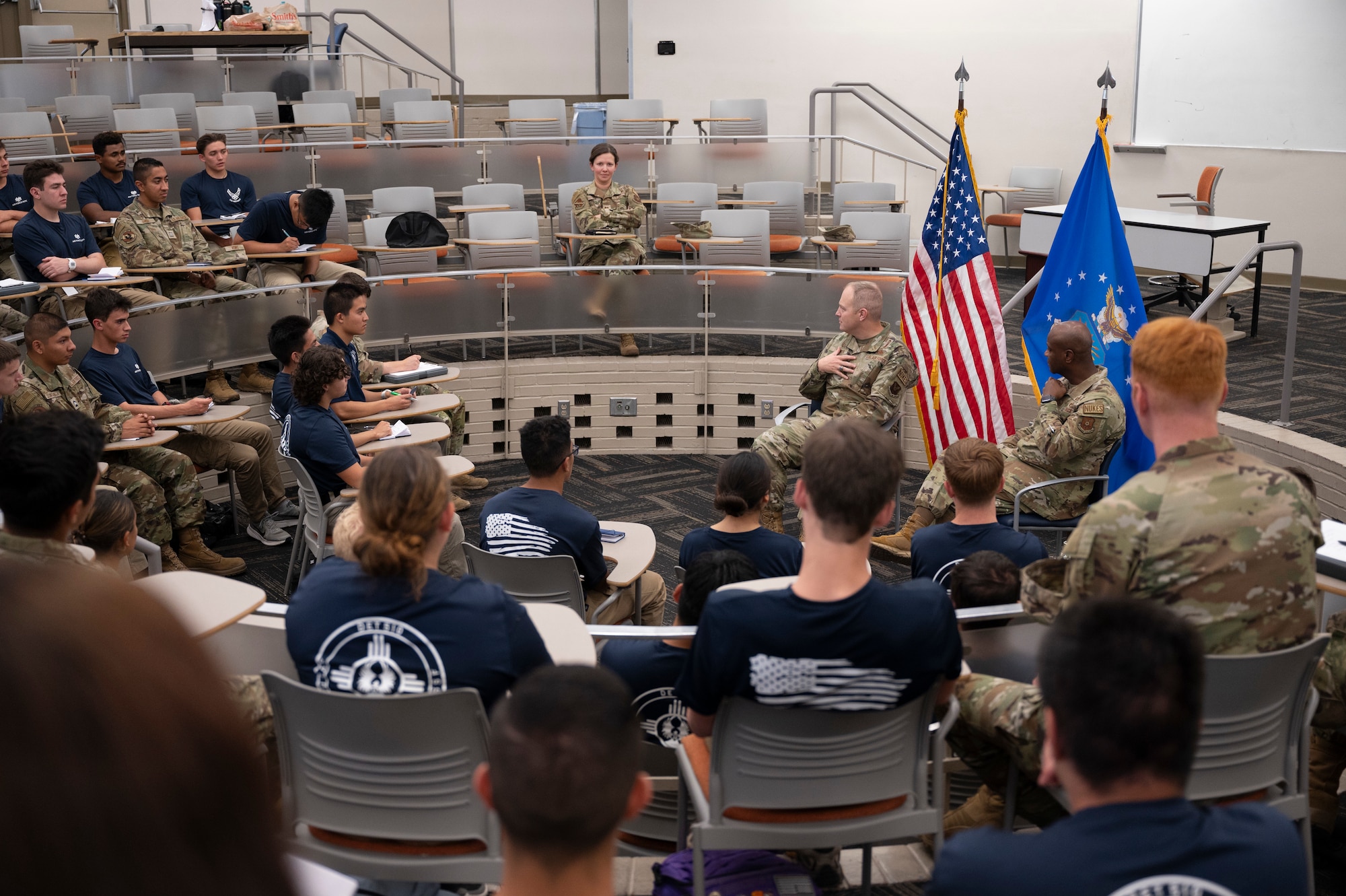 A group of people listen to a presentation.