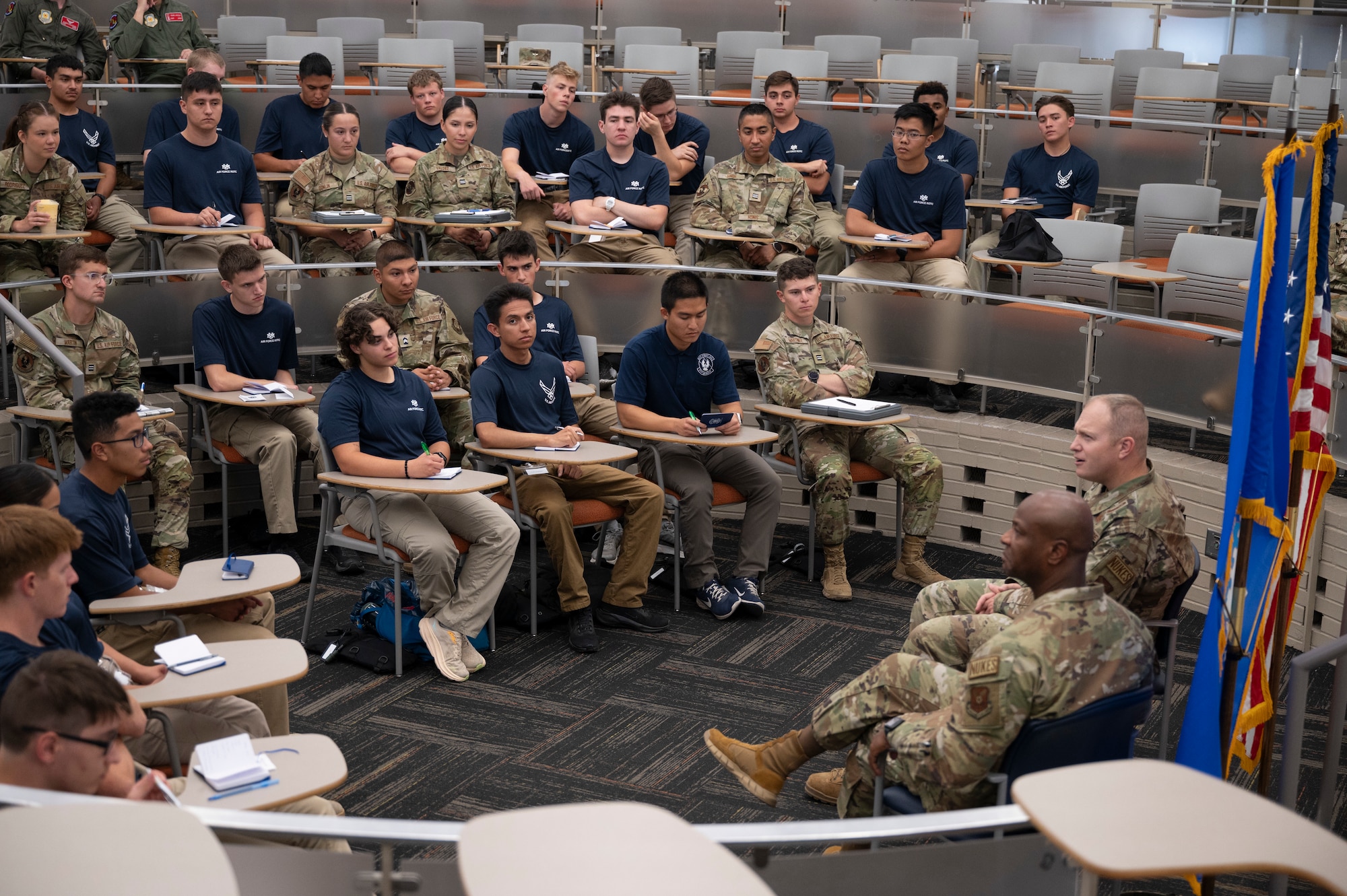 A group of people listen to a presentation.