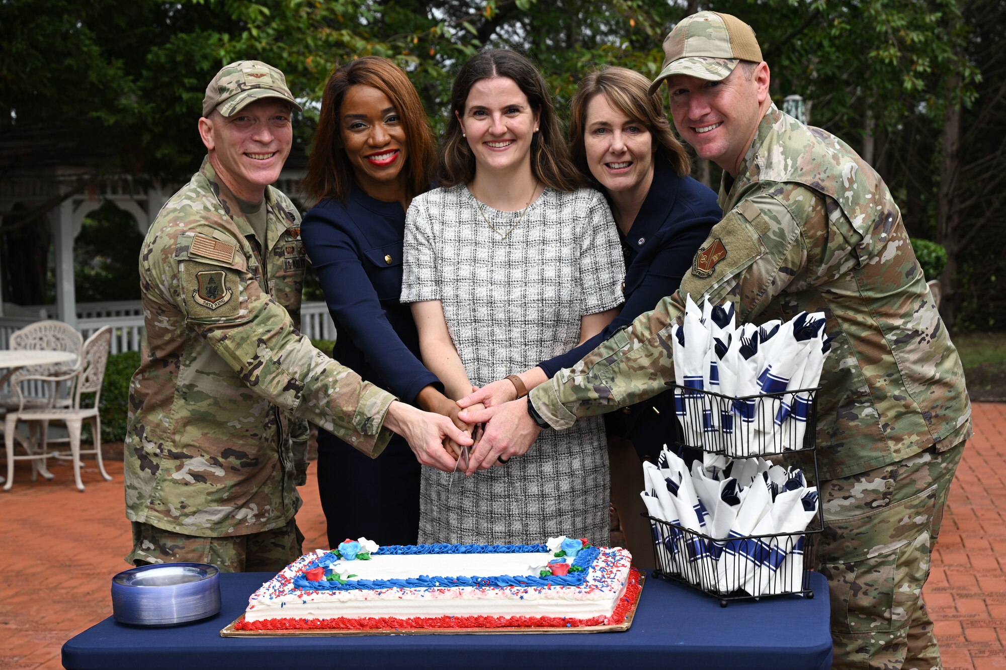 Joint Base Andrews Fisher House supporters prepare to cut the ceremonial cake during the 30th anniversary event of the Fisher House, Joint Base Andrews, Md., Sept. 26, 2024. The event celebrated three decades of unwavering support to military families, highlighting the Fisher House's mission of providing a "home away from home" for those receiving medical care at nearby hospitals. (U.S. Air Force photo by Airman 1st Class Gianluca Ciccopiedi)