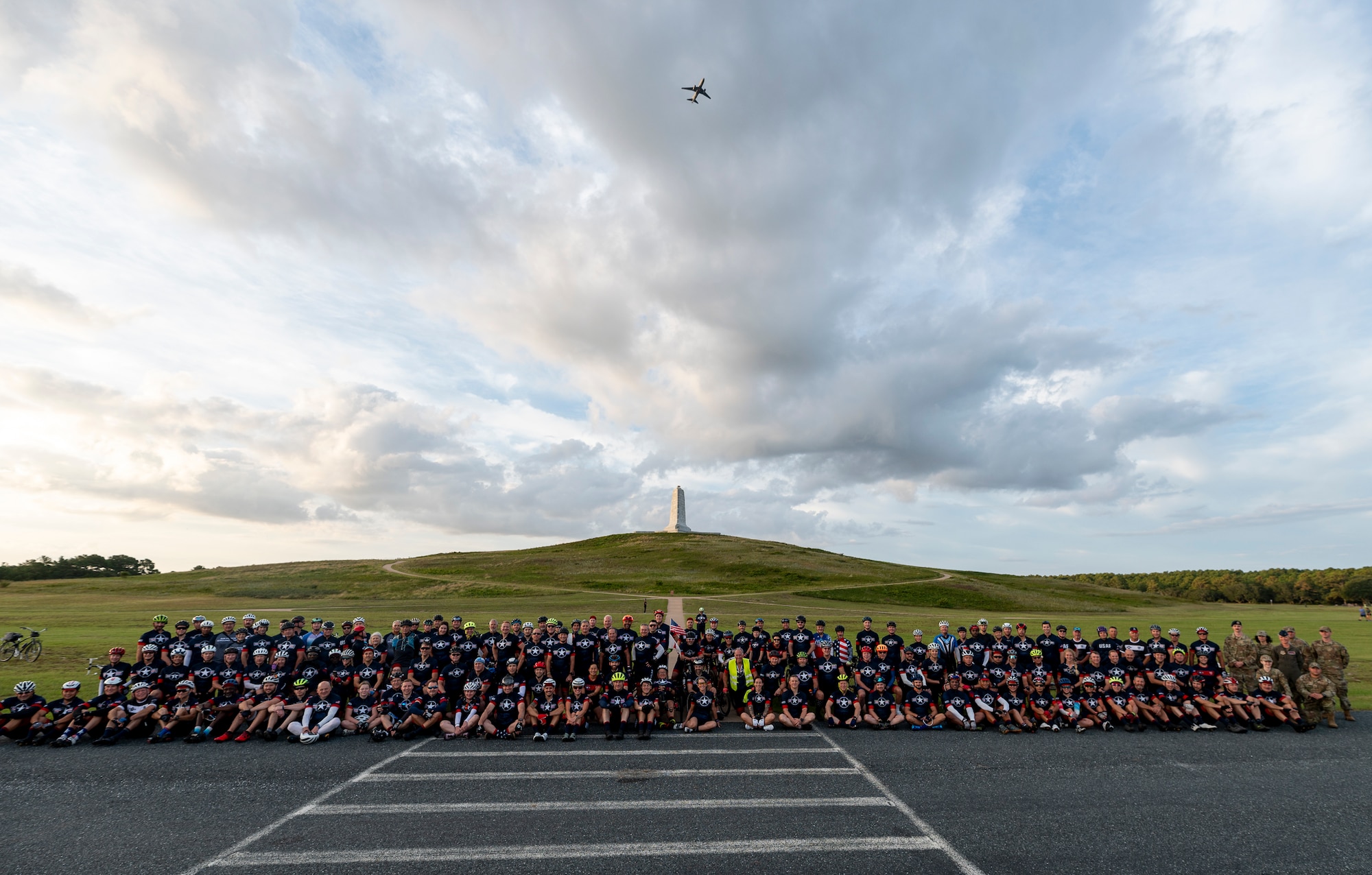 Group of bicycle riders pose for a group photo.