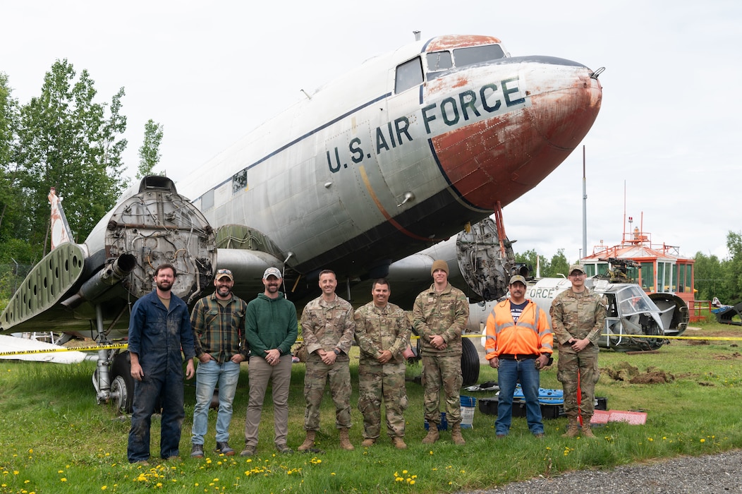 A group of people standing in front of plane