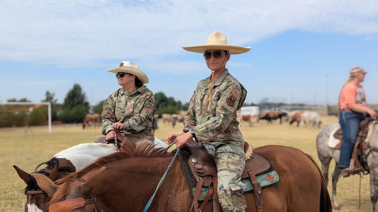 U.S. Air Force Senior Master Sgt. Nancy Chavez Mozingo (right), 97th Logistics Readiness Squadron first sergeant, and Col. Claudia Eid, 97th Medical Group commander, ride horses during the annual cattle drive at Altus Air Force Base, Oklahoma, Aug. 22, 2024. Chavez Mozingo grew up in an agricultural community similar to that of Altus. (courtesy photo by Senior Master Sgt. Nancy Chavez-Mozingo)