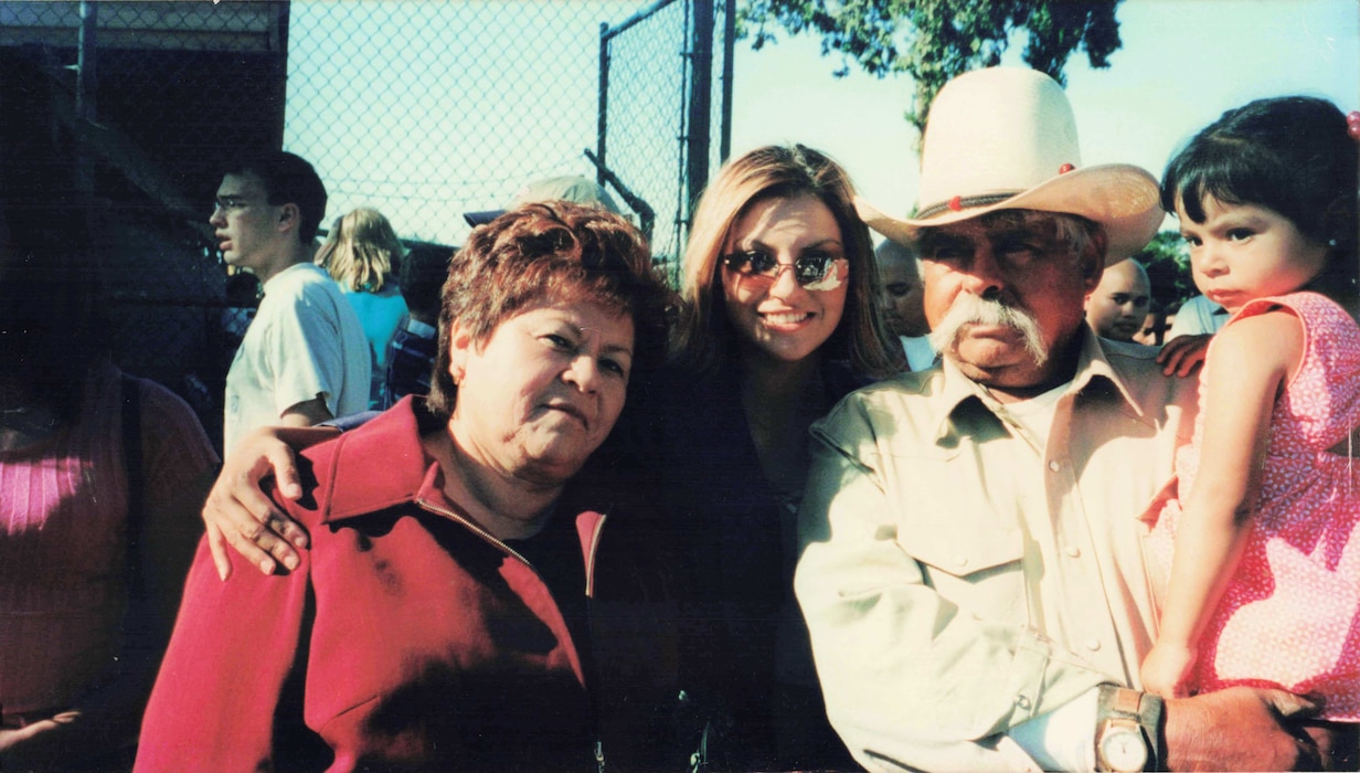 U.S. Air Force Senior Master Sgt. Nancy Chavez Mozingo, 97th Logistics Readiness Squadron first sergeant (center) poses for a photo with her mother, Maria Chavez, father, Manuel Chavez, and niece, Sofia, during her high school graduation in Tracy, Calif. in June of 2002. Chavez Mozingo explained that family and education were always important values for her family growing up. (courtesy photo by Senior Master Sgt. Nancy Chavez Mozingo)