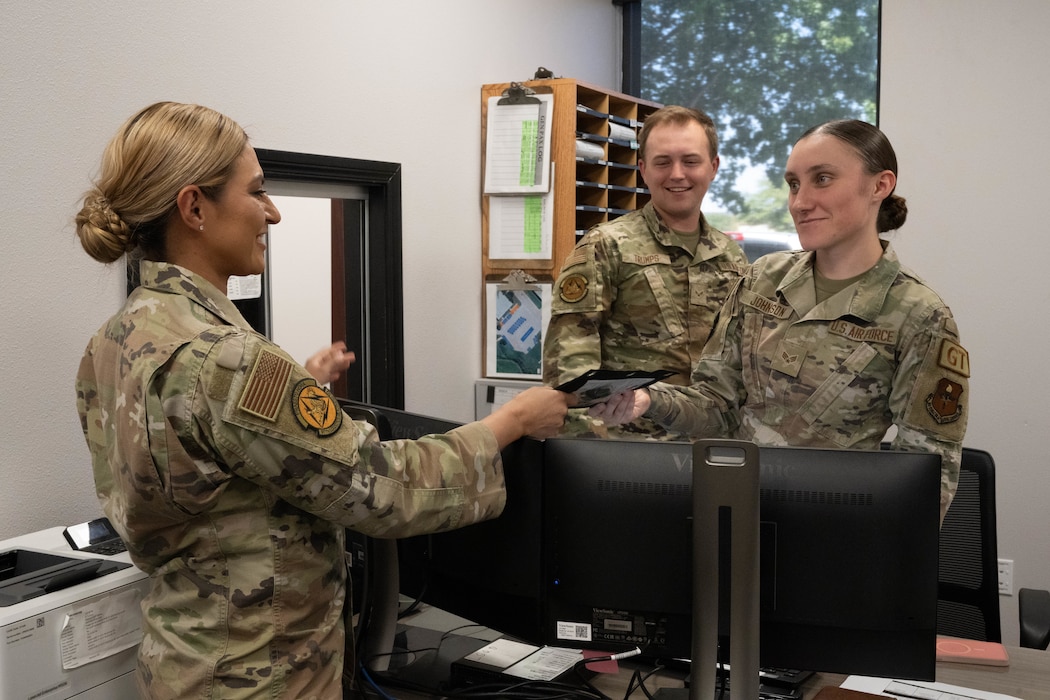 U.S. Air Force Senior Master Sgt. Nancy Chavez Mozingo, 97th Logistics Readiness Squadron first sergeant, interacts with Senior Airman Katelyn Johnson and Airman 1st Class Ashton Trumps, 97th Logistics Readiness Squadron ground transportation dispatchers, at Altus Air Force Base, Oklahoma, Oct. 1, 2024. As a first sergeant, Chavez Mozingo mentioned she enjoys helping Airmen in whatever way she can. (U.S. Air Force photo by Senior Airman Miyah Gray)