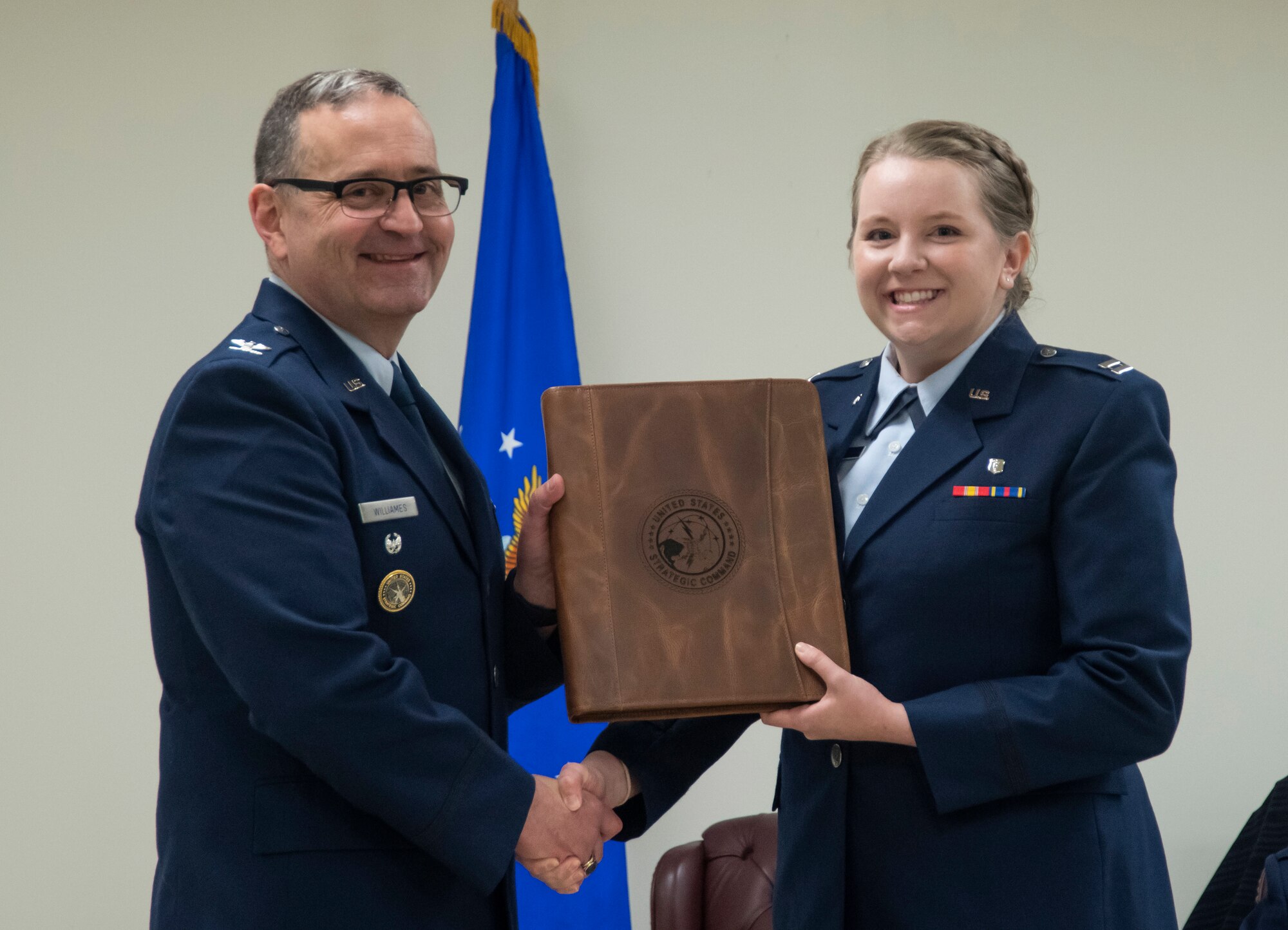 Capt. receives certificate from Col.
