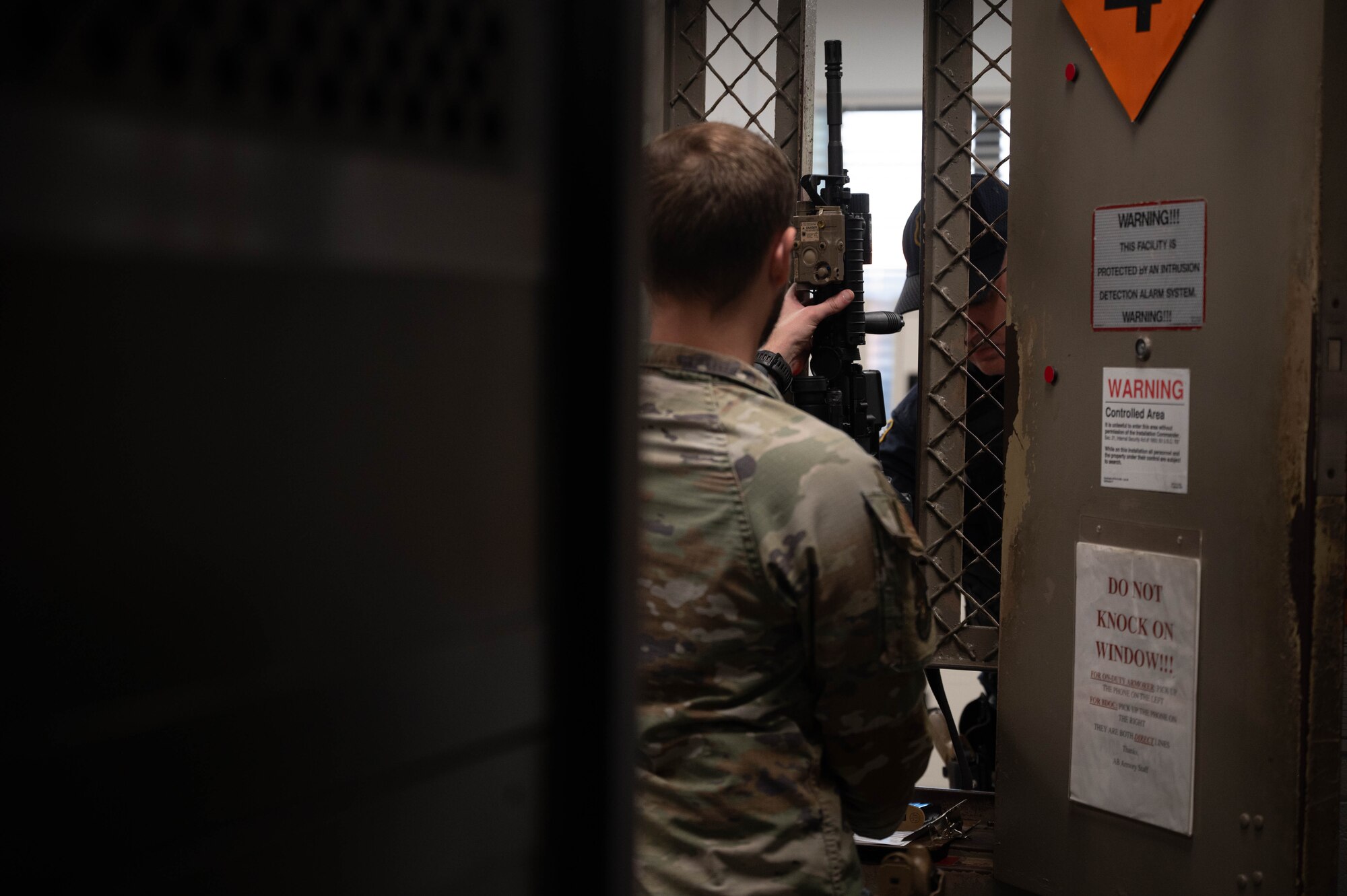 An armorer issues out a rifle