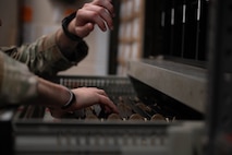 An Airman retrieves ammunition