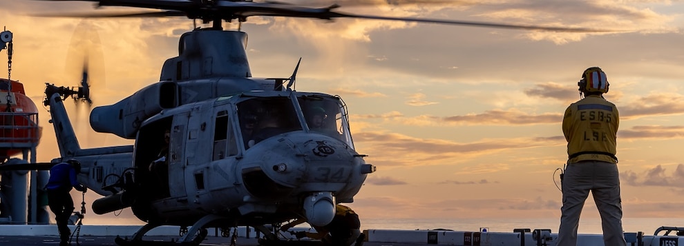 U.S. Sailors assigned to the expeditionary sea base USS Miguel Keith (ESB 5) remove chains from a UH-1Y Venom attached to Marine Medium Tiltrotor Squadron (VMM) 165 (Reinforced), 15th Marine Expeditionary Unit, before flight operations while underway in the Philippine Sea, Sept. 28, 2024.