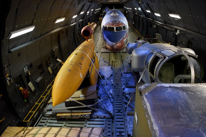 Three large aircraft parts sitting inside a larger aircraft
