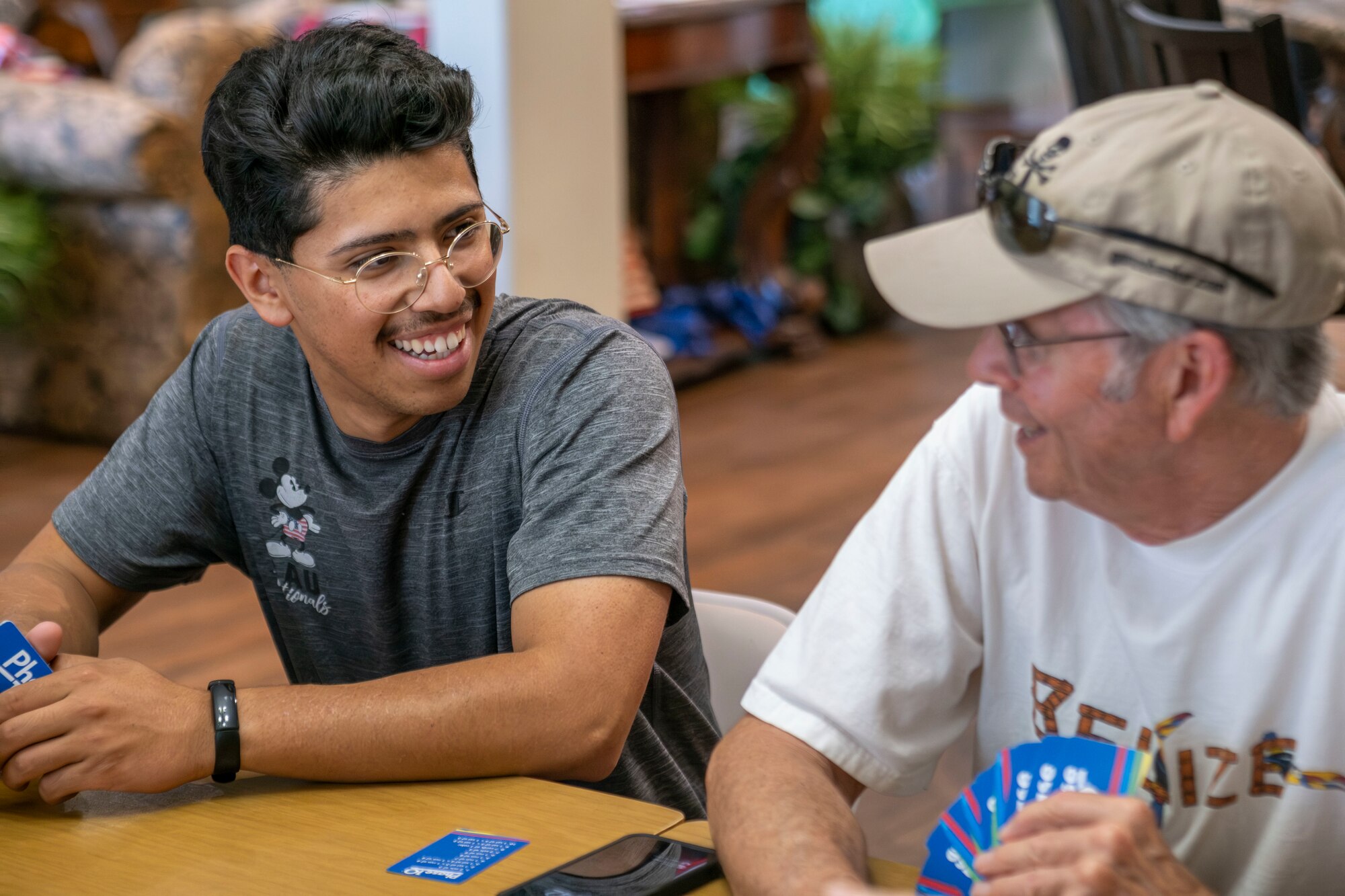 men play cards together while laughing