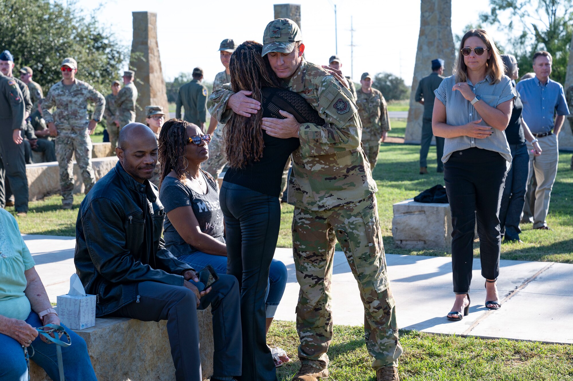 U.S. Air Force Col. Justin Diehl, 317th Airlift Wing commander, hugs a loved one of Senior Airman Quinn Johnson-Harris, 39th Airlift Squadron loadmaster, at the TORQE 62 memorial ceremony at the Dyess Memorial Museum in Abilene, Texas, Oct. 2, 2024. Families and friends gathered for the memorial to not only mourn their loss, but to celebrate the fallen heroes’ lives. (U.S. Air Force photo by Airman 1st Class Emma Anderson)