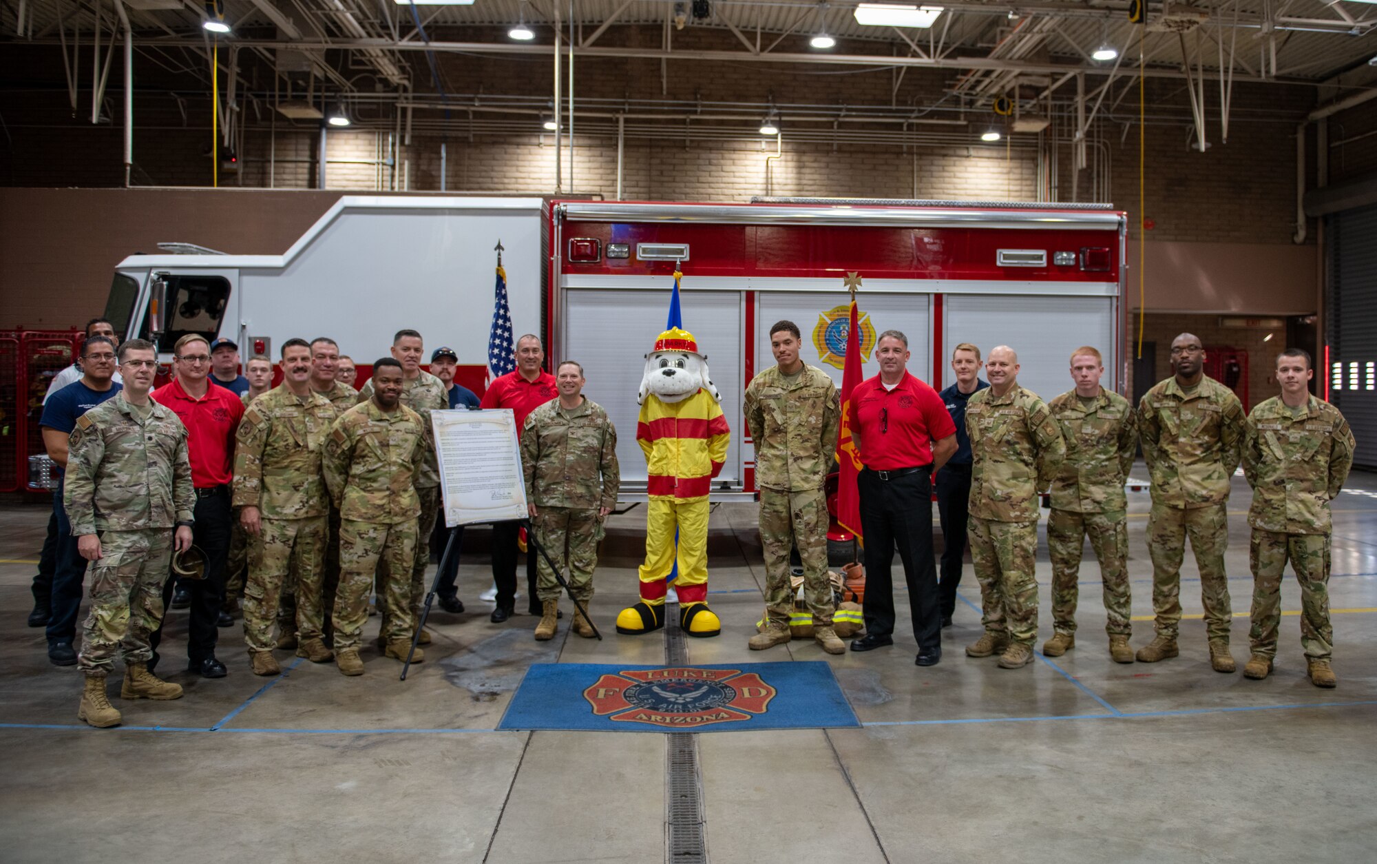 U.S. Air Force Airmen and civilians take a photo together during Fire Prevention Week.