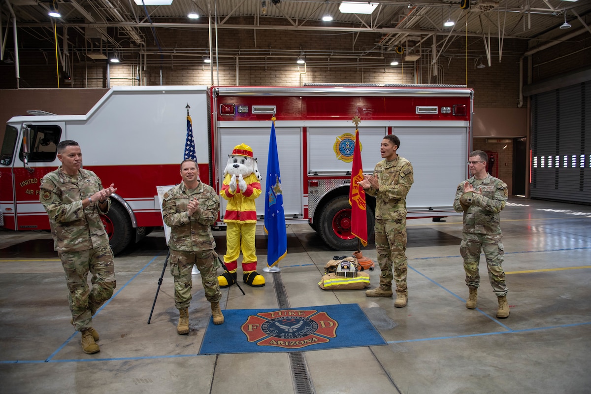 Airmen clap at the 56th Fighter Wing fire station.