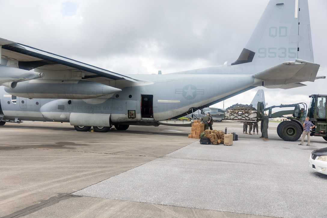 U.S. Marines with III Marine Expeditionary Force load cargo onto a KC-130J Super Hercules aircraft with Marine Aerial Refueler Transport Squadron 152, Marine Aircraft Group 12, 1st Marine Aircraft Wing at Kadena Air Base, Okinawa, Japan, Oct. 5, 2024.