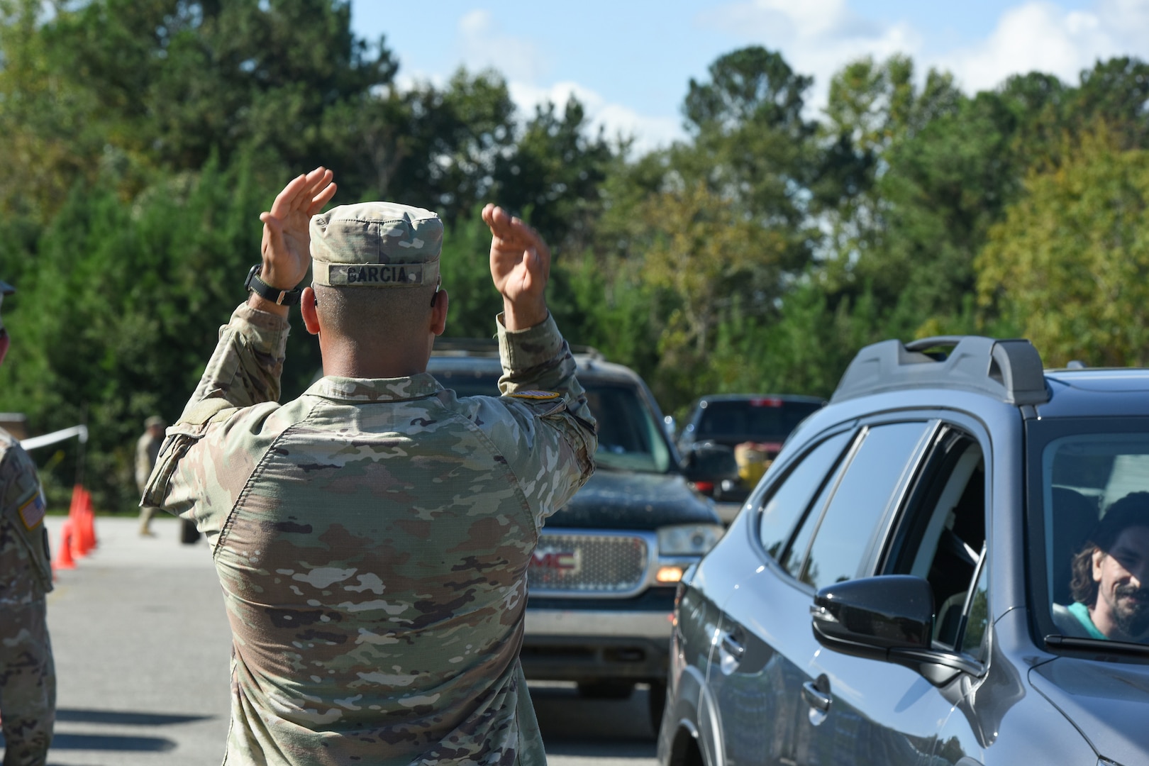 U.S. Army Staff Sgt. Kevin Garcia, a tank commander assigned to Bravo Company, 1-118th Infantry Regiment, Armored Brigade Combat Team, distributes water and supplies in Gaffney, South Carolina, Oct. 2, 2024.