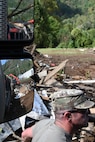 Tennessee Air National Guardsmen coordinating a convoy to the debris drop site in Hampton, Tennessee, on Oct. 2, 2024.