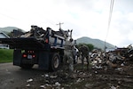 Tennessee Air National Guardsmen loading a truck with debris in Hampton, Tennessee, on Oct. 2, 2024.