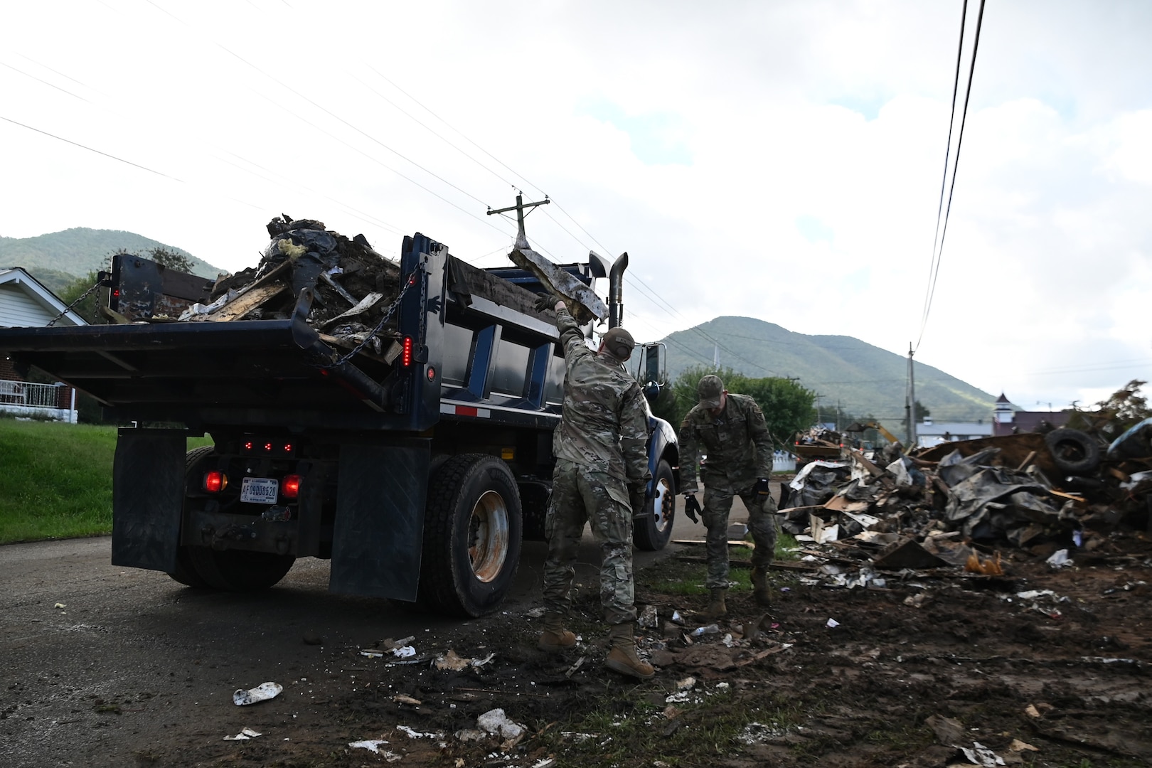 Tennessee Air National Guardsmen loading a truck with debris in Hampton, Tennessee, on Oct. 2, 2024.