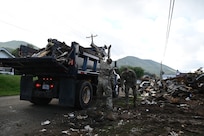 Tennessee Air National Guardsmen loading a truck with debris in Hampton, Tennessee, on Oct. 2, 2024.