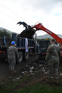 Tennessee Air National Guardsmen load trucks with debris in Hampton, Tennessee, on Oct. 2, 2024.