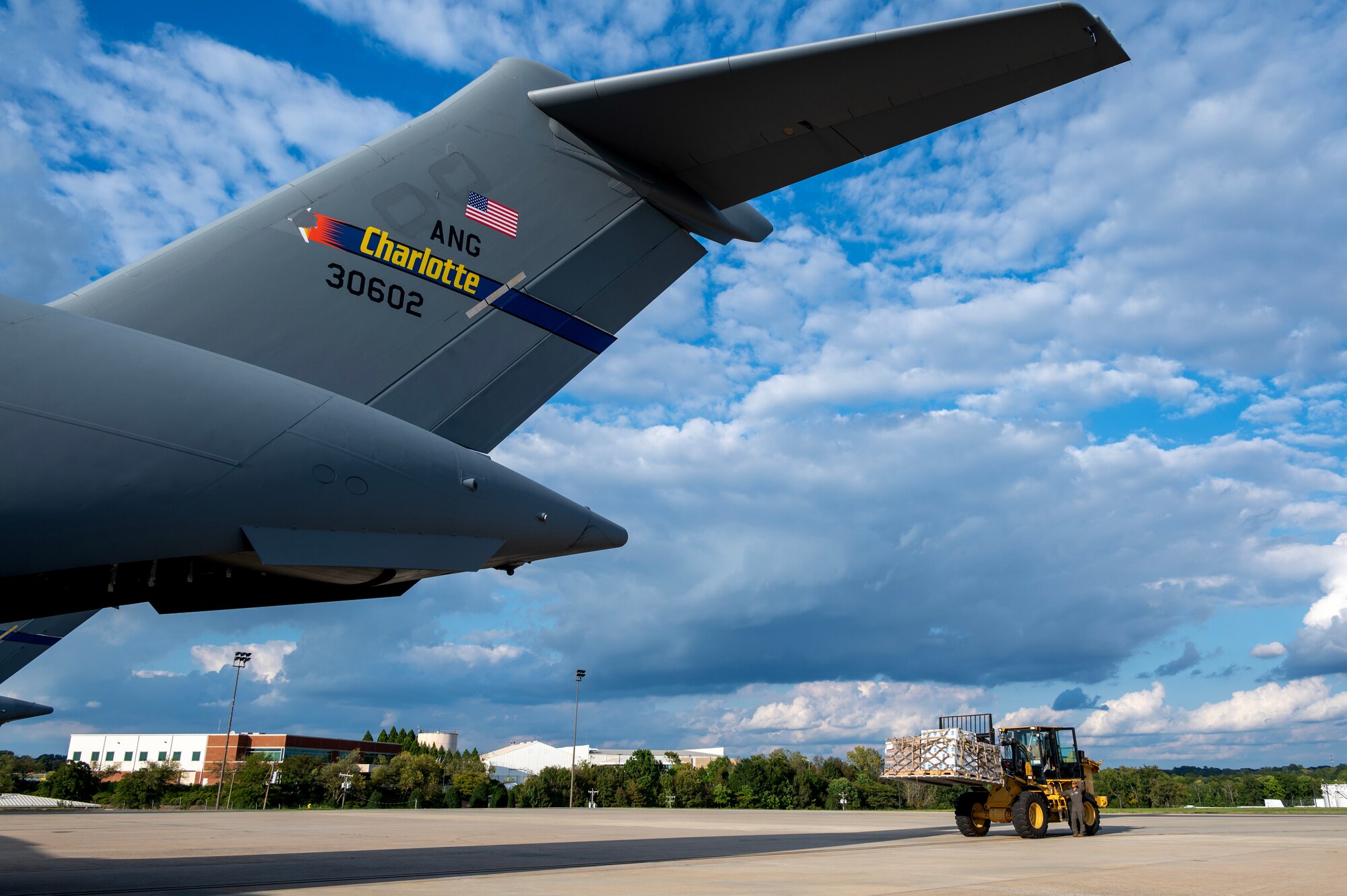 Members of the North Carolina Air National Guard load hurricane relief pallets onto a C-17 Globemaster III for delivery to Western North Carolina in support of humanitarian efforts following Tropical Storm Helene recovery at the North Carolina Air National Guard, Charlotte-Douglas International Airport, October 3, 2024. The cargo delivered aboard the C-17 consisted of Meals Ready to Eat (MREs), water, medication and other vital supplies (U.S. Air National Guard photo by Staff Sgt. Reanna Hartgrove)