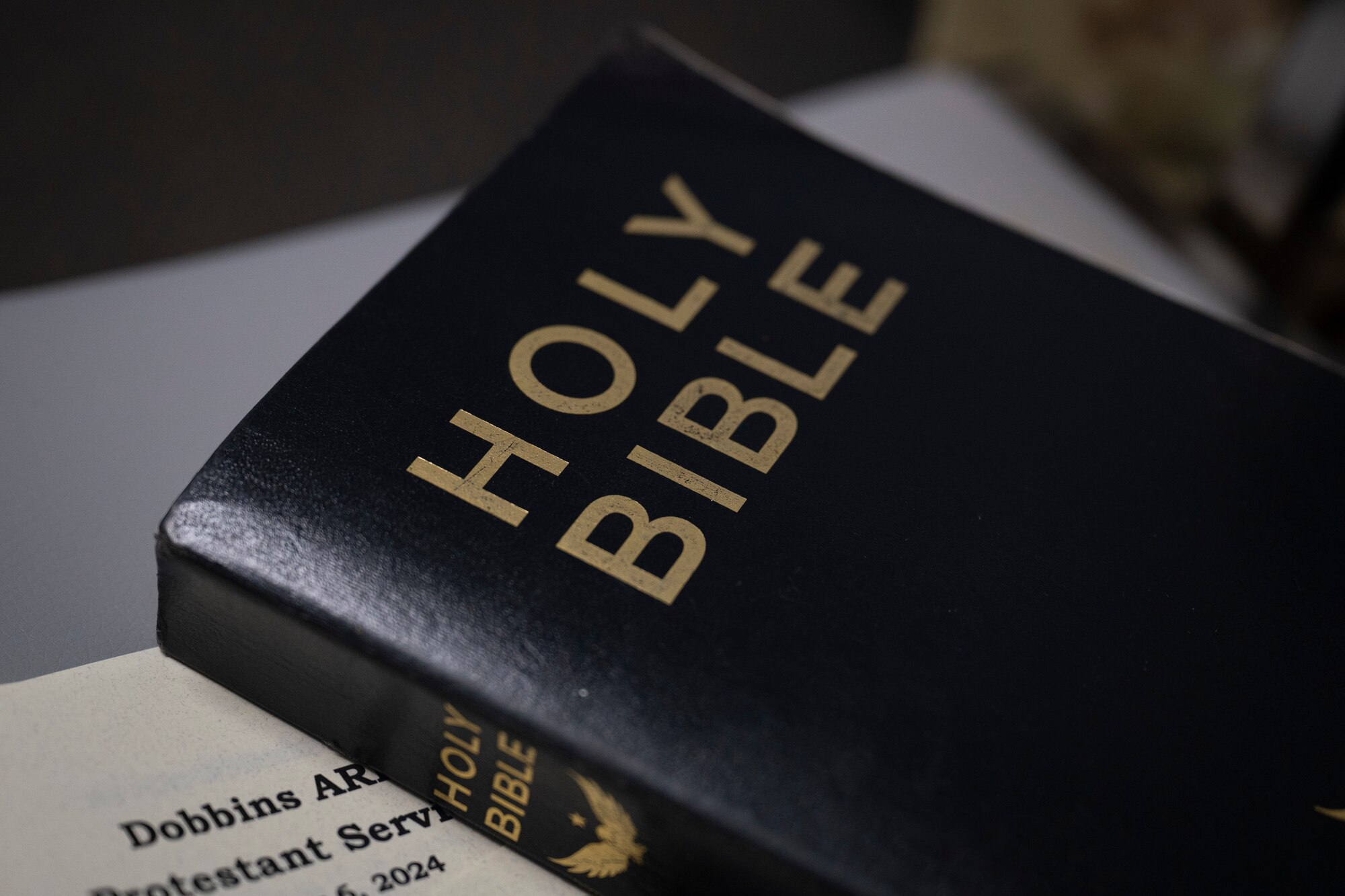 A Bible rests on a chair.