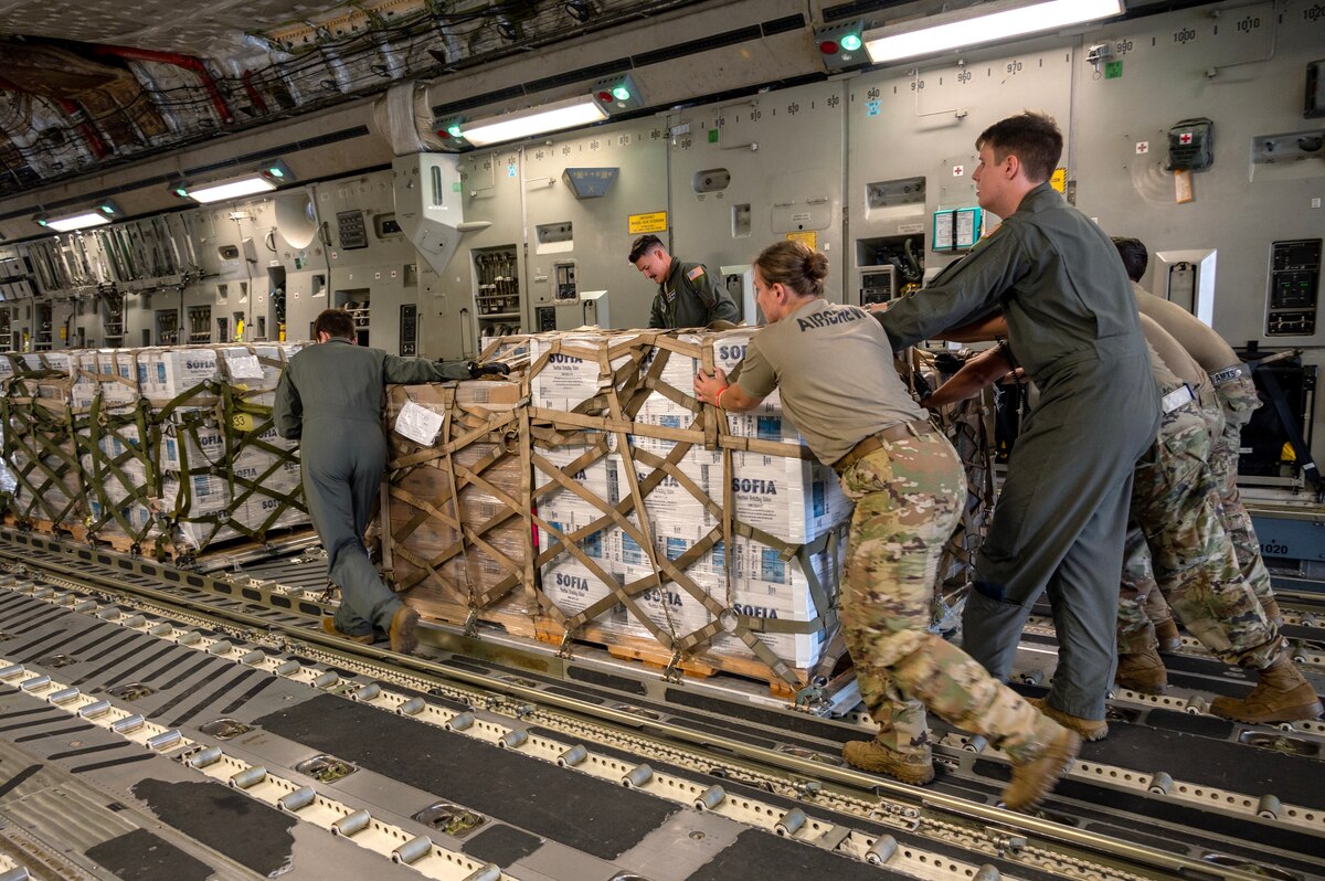 Members of the North Carolina Air National Guard push a hurricane relief pallet into position on a C-17 Globemaster III for delivery to Western North Carolina in support of humanitarian efforts following Tropical Storm Helene at the North Carolina Air National Guard, Charlotte-Douglas International Airport, October 3, 2024. The cargo delivered aboard the C-17 consisted of Meals Ready to Eat (MREs), water, medication and other vital supplies. (U.S. Air National Guard photo by Staff Sgt. Reanna Hartgrove)