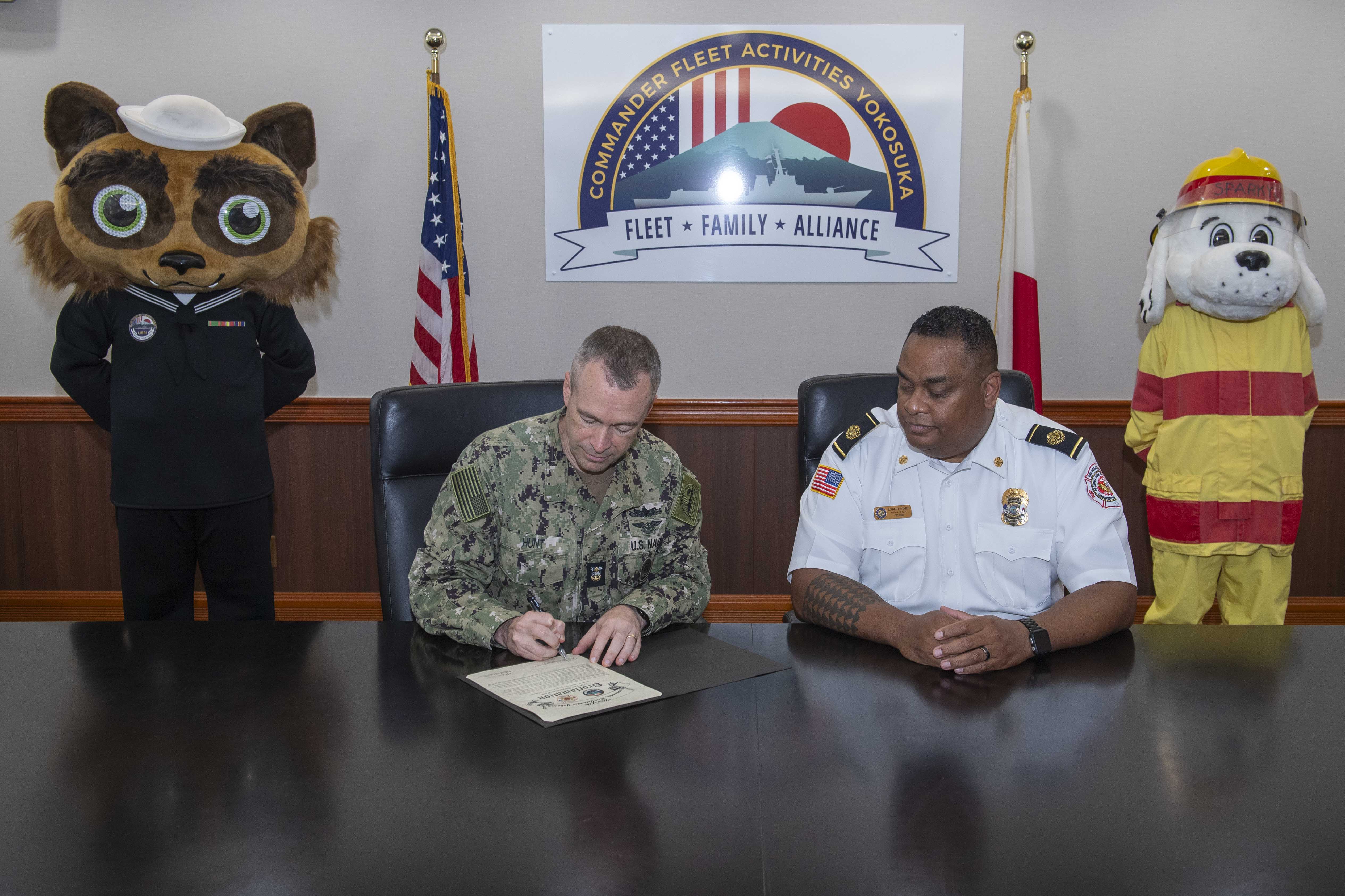 Command Master Chief Dennis Hunt signs Commander, Fleet Activities Yokosuka’s (CFAY) Fire Prevention Week proclamation.