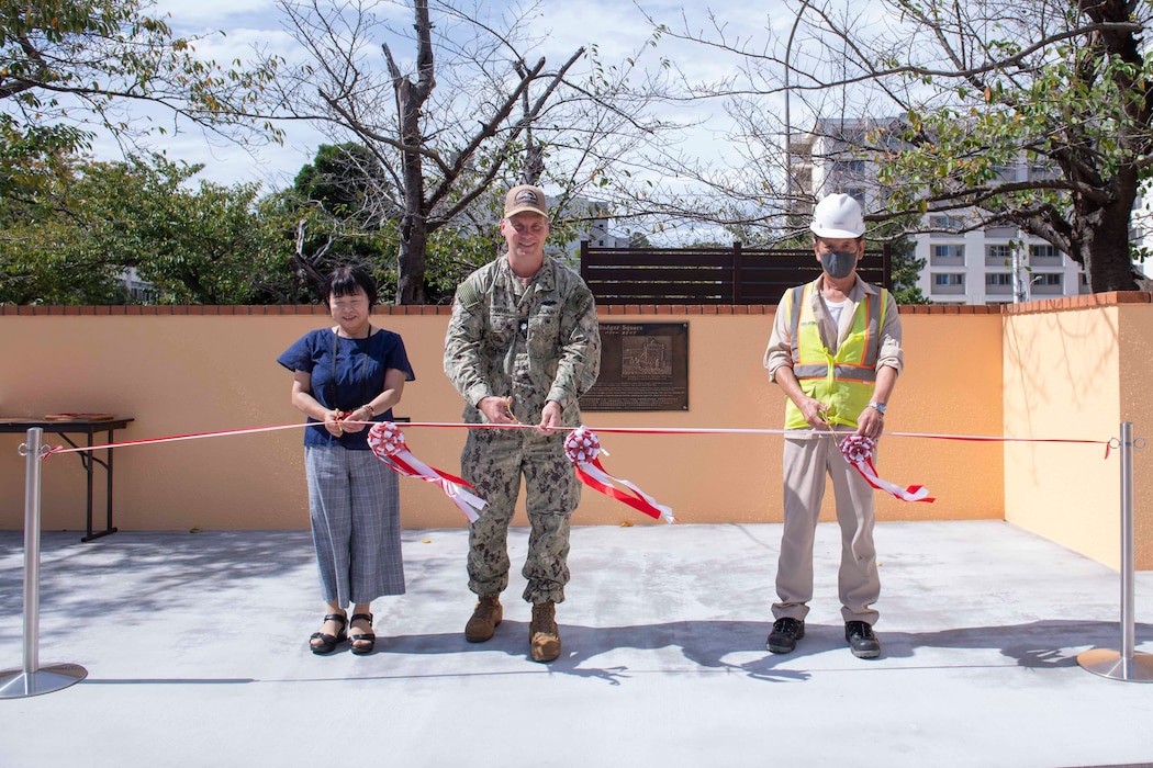 mdr. Tyler Scharer, public works officer for Commander, Fleet Activities Yokosuka (CFAY), center, cuts a ribbon during a ribbon-cutting ceremony celebrating the opening of Badger Square at the installation’s Kosano Park.