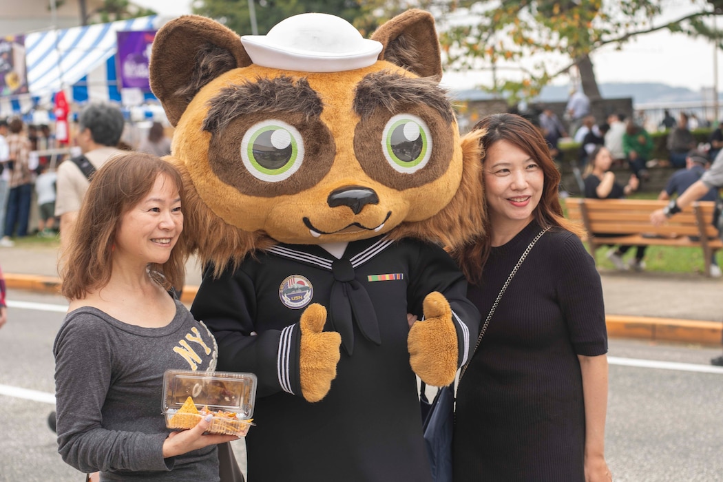 Local community members pose for photos with Commander, Fleet Activities Yokosuka’s (CFAY) mascot Yokopon during Yokosuka Friendship Day 2024 at CFAY.