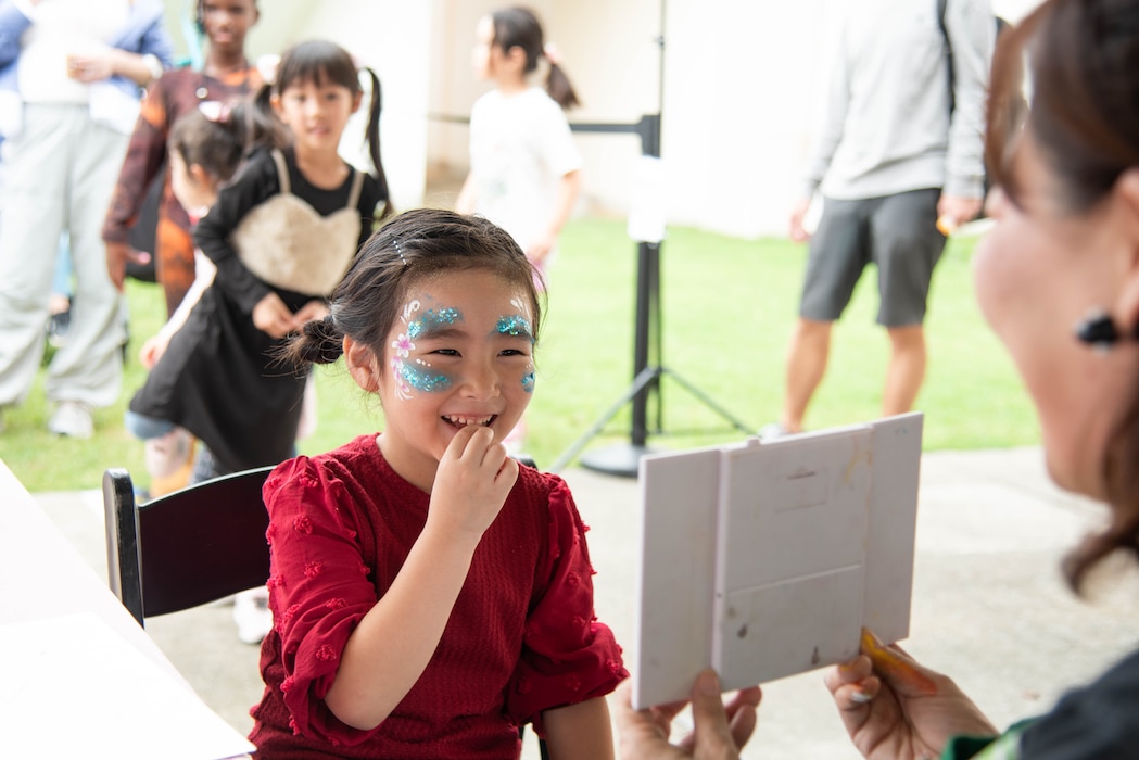 Visiting child gets her face painted during the 46th annual Friendship Day celebration onboard Commander, Fleet Activities Yokosuka (CFAY).