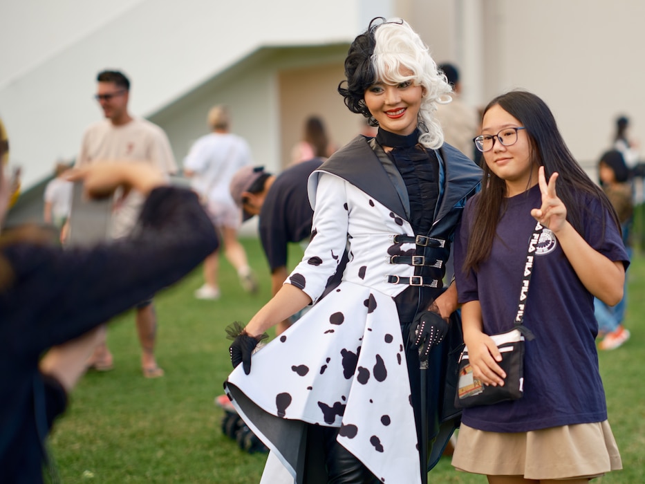 A young girl poses with a street performer at the 46th Annual Yokosuka Friendship Day held throughout Commander, Fleet Activities Yokosuka (CFAY) October 6, 2024.