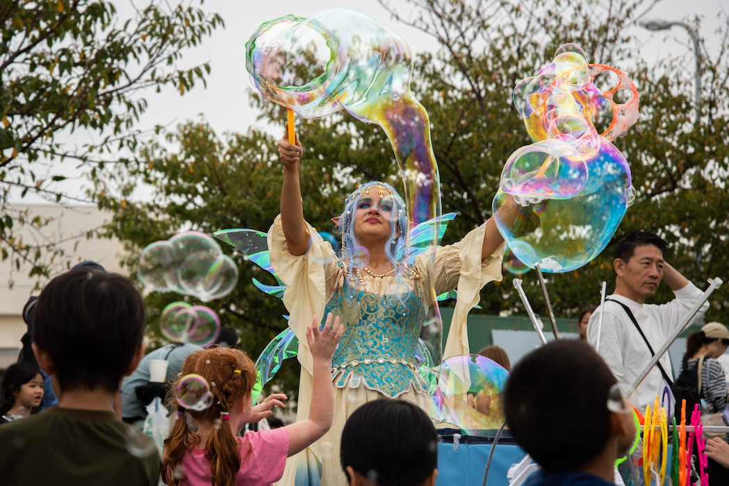 A street performer conducts a bubble performance onboard Commander, Fleet Activities Yokosuka (CFAY) during the 46th annual Friendship Day celebration hosted by CFAY. Friendship Day is an annual open base event where the CFAY community and City of Yokosuka join together to highlight the friendship between the local Japanese community and the U.S. Navy.