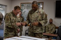 U.S. Air Force Col. Paul Davidson, left, 35th Fighter Wing Commander, and U.S. Air Force 2nd Lt. Kade Forrester, 35th Contracting Squadron acquisition flight commander, finalize a purchase during the end of fiscal year closeout at Misawa Air Base, Japan, Sept. 30, 2024.