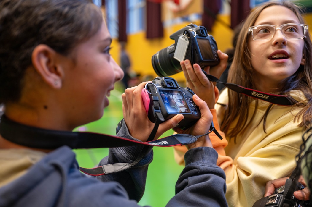 Students take pictures at an event recognizing the teacher of the year.