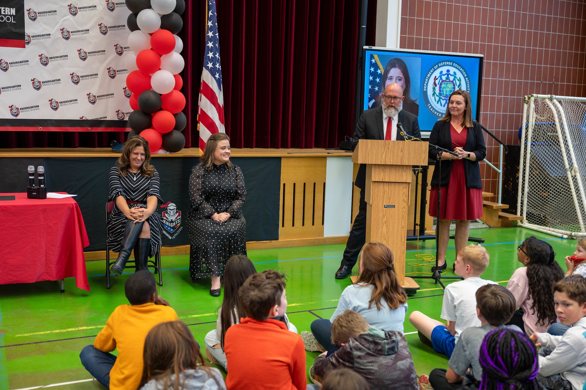 Kaiserslautern Middle School principal speaks to attendees of an event.